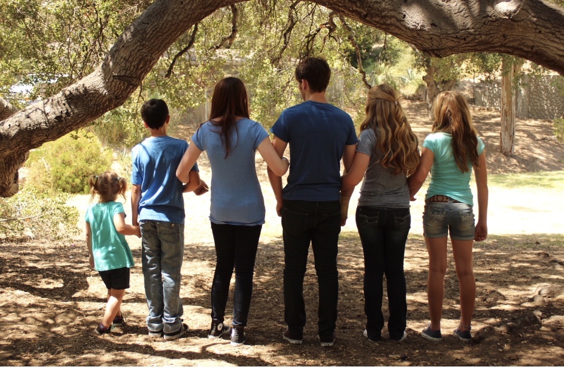 Youth gathered under oak trees in park